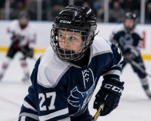 A young athlete wearing a properly fitted sports helmet during a youth hockey game