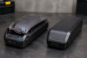 Swollen lithium-ion battery showing visible damage that may indicate overheating or fire risk